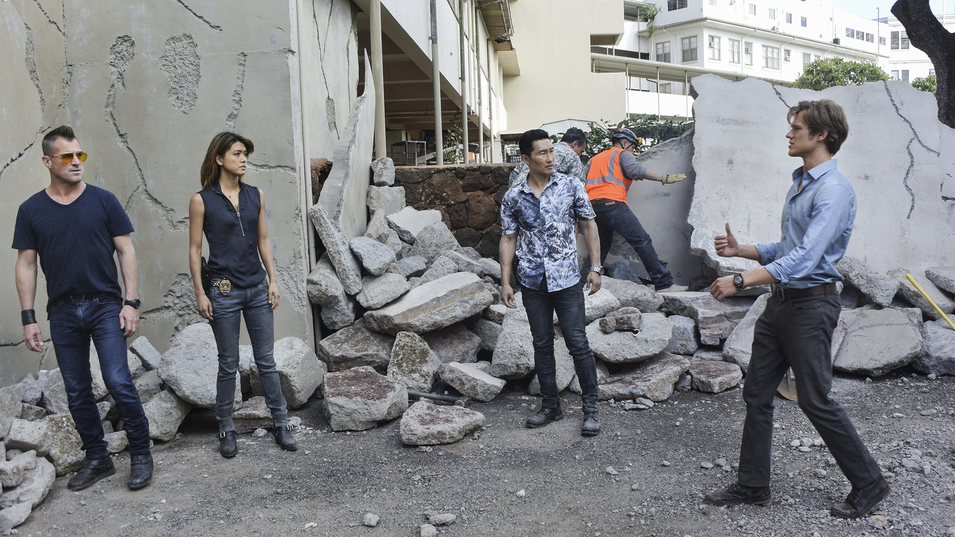 The team goes over the potential options amidst the earthquake wreckage.