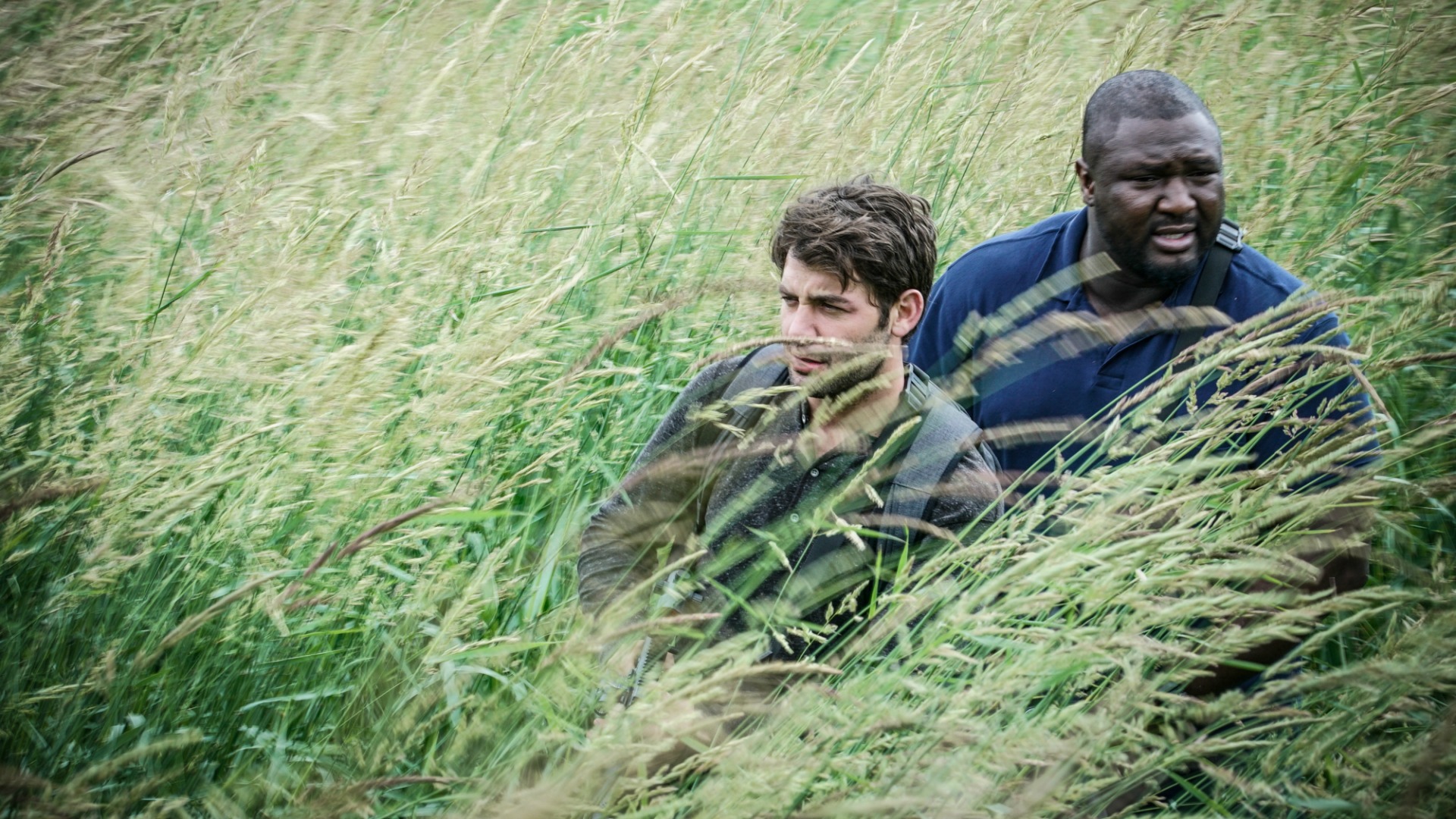 Jackson and Abraham move through high grass in their search.