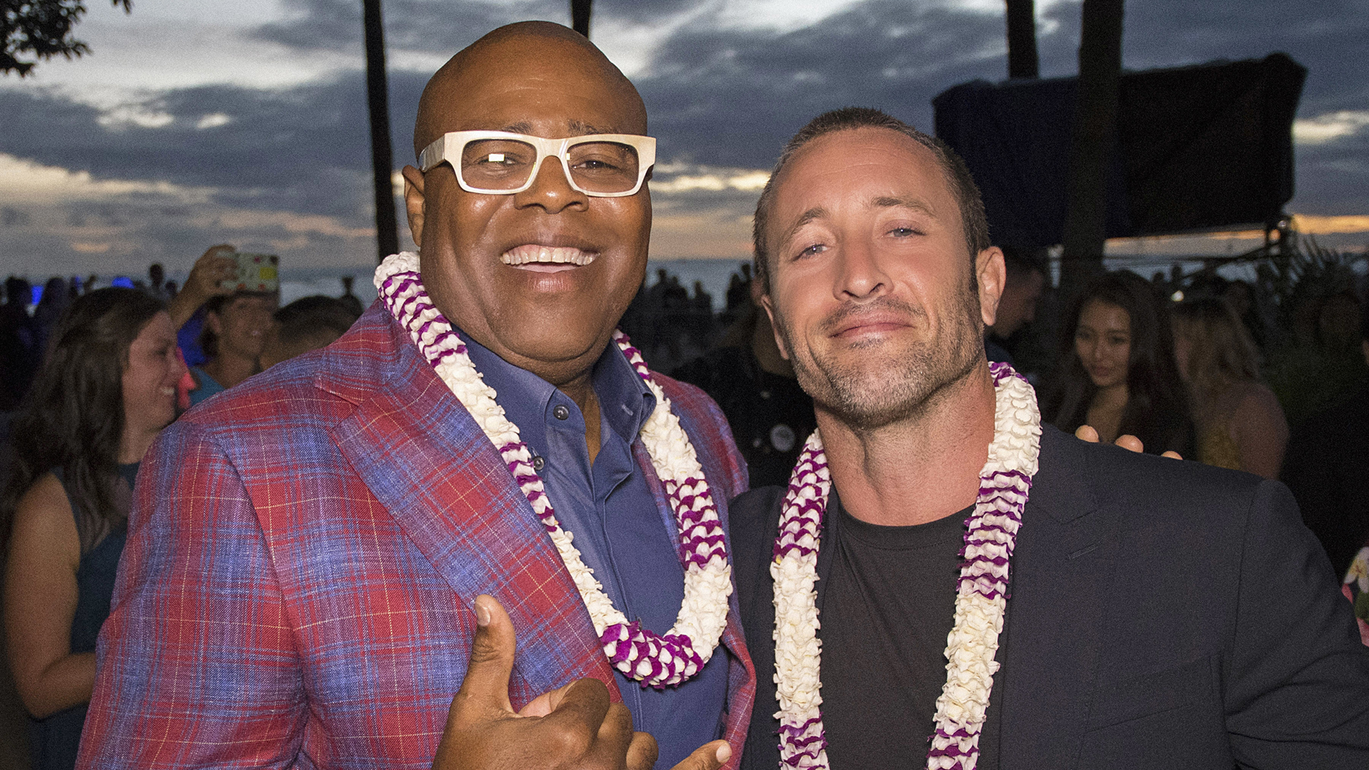 Chi McBride and Alex O'Loughlin pose together in their matching leis. 