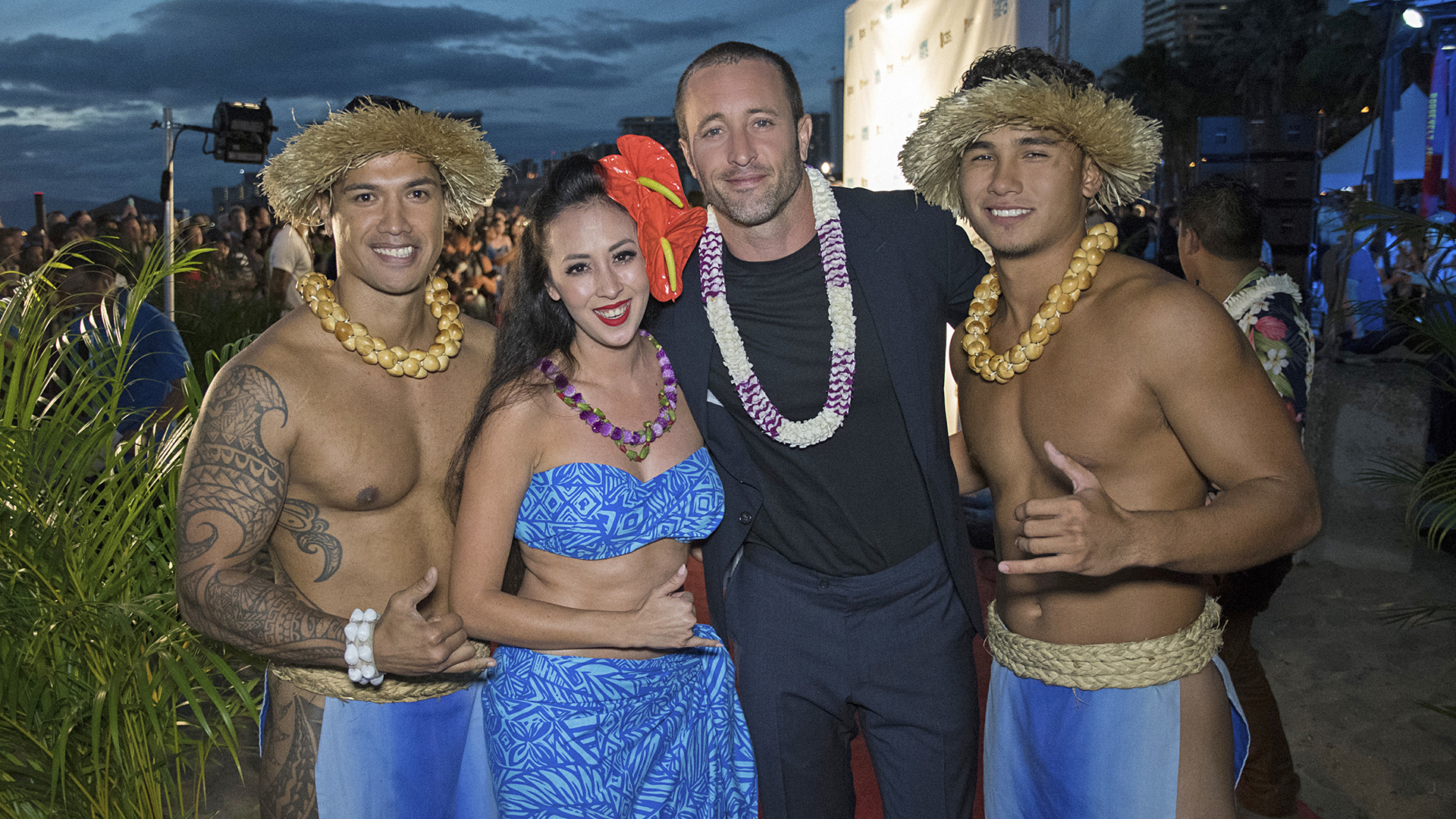 Alex O'Loughlin poses alongside a group dressed up for the festivities.